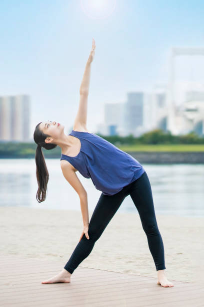 istock Young woman doing yoga on the beach 1286313018