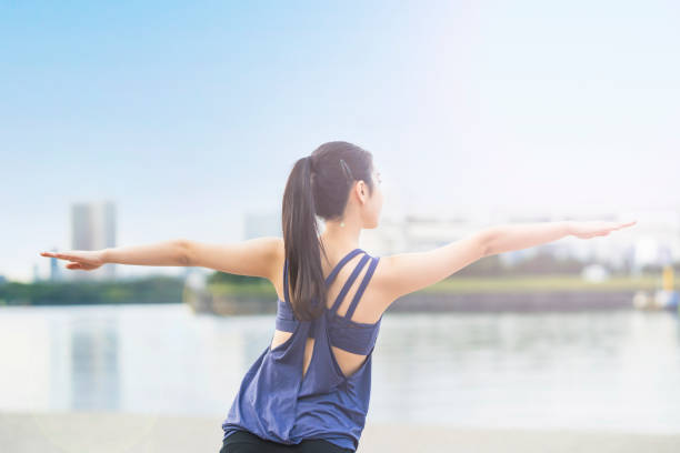 istock Young woman doing yoga on the beach 1286313445