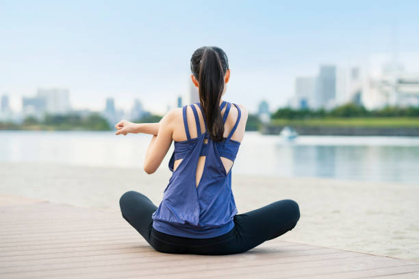 istock Young woman doing yoga on the beach 1286314118