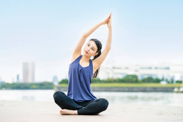 istock Young woman doing yoga on the beach 1286314163