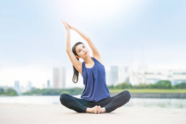 istock Young woman doing yoga on the beach 1286314752