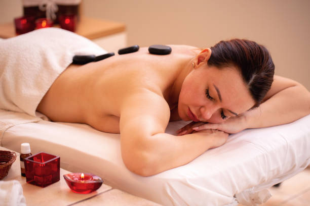 istock Middle aged woman lying on the table in the massage center 1286317621