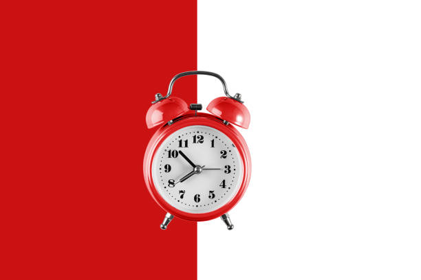 istock Old red alarm clock on red and white background. empty template for text 1286319625