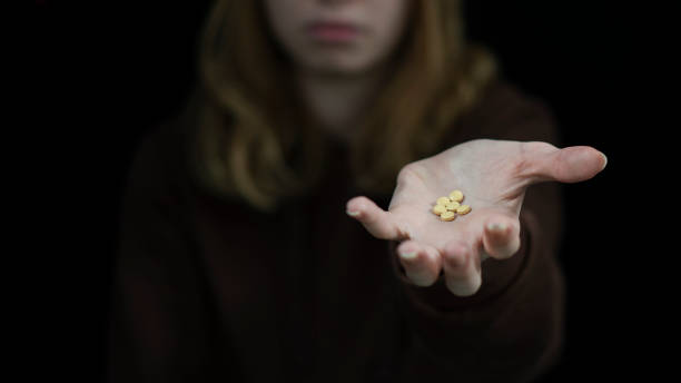 hand of an addict holding pills. addiction concept and international day against addiction. - narcotic teenager cocaine drug abuse imagens e fotografias de stock
