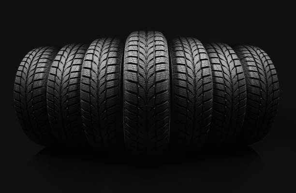 istock Car tires on black background 1286325721