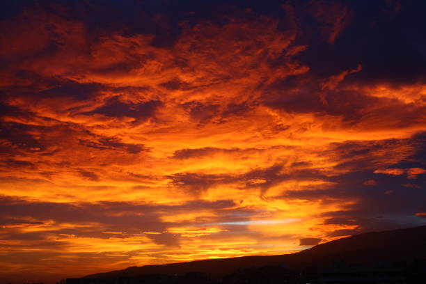 istock Orange clouds at sunset. Gloomy sunset. Sunset and mountain. 1286325851