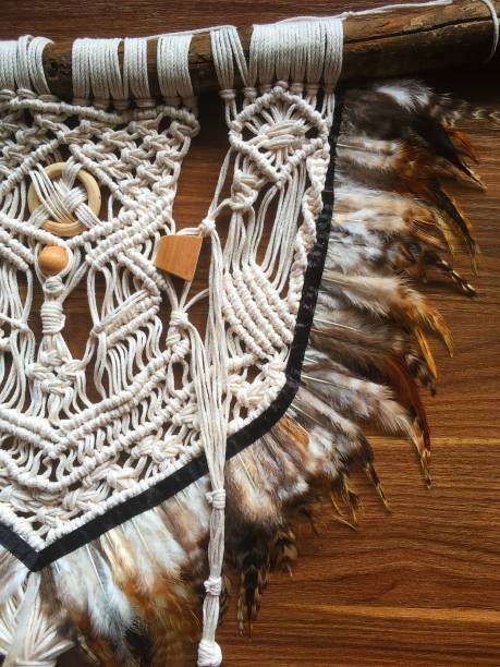 istock Handmade wall hanging white color with feathers. Home decor photo 1286326434