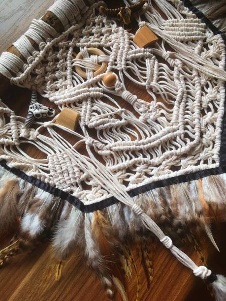 istock Handmade wall hanging white color with feathers. Home decor photo 1286326436