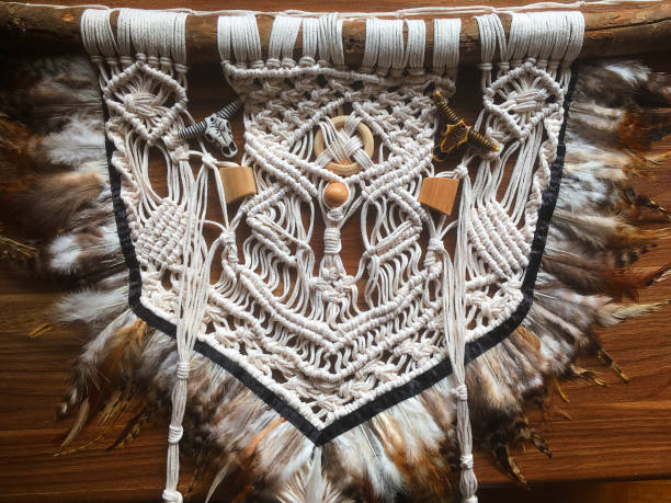 istock Handmade wall hanging white color with feathers. Home decor photo 1286326444