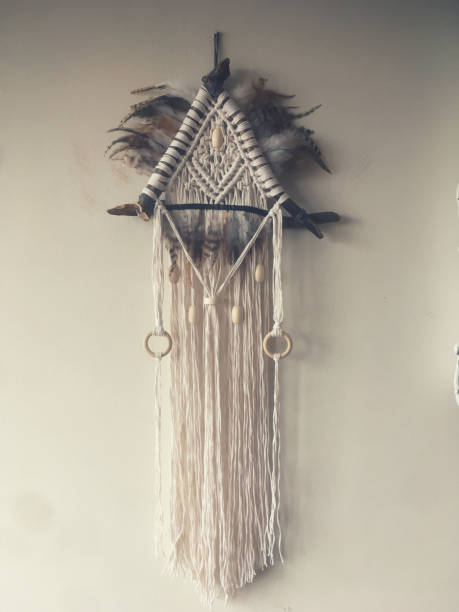 istock Handmade wall hanging white color with feathers. Home decor photo 1286326459