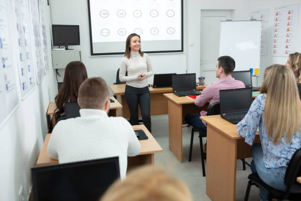 istock Female driving instructor explaining traffic signs meaning to her students i 1286326572