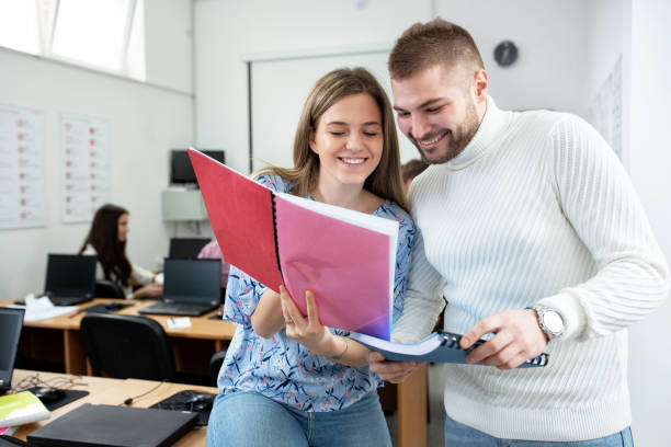 istock Two university students smiling in the classroom, colleagues concept 1286329314