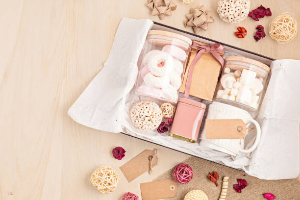 istock Preparing care package, seasonal gift box with marshmallow, tea,coffee or cacao box and christmas ornament 1286329502