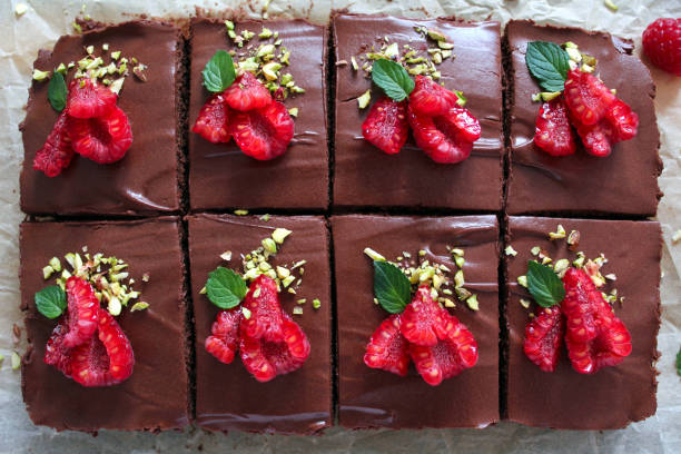 istock Chocolate mousse brownies with raspberry on dark background. 1286333850