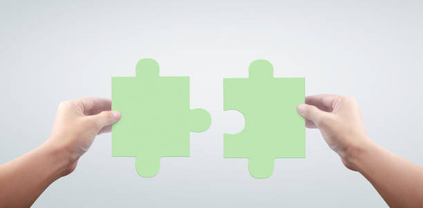 istock Hand of connecting jigsaw puzzle,Concept of teamwork 1286334272