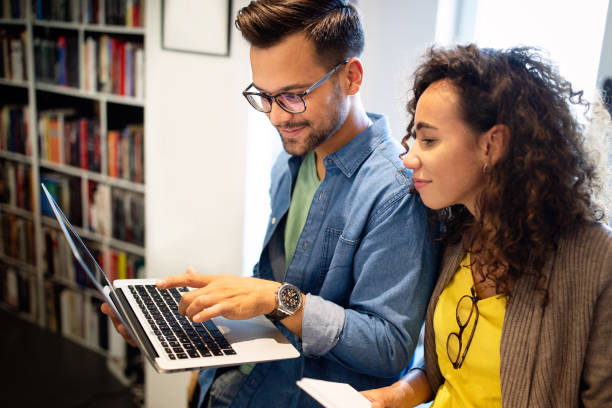 istock Happy colleagues looking at laptop while brainstorming in creative office 1286336846