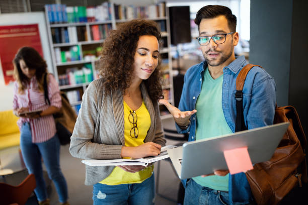 istock Group of college students studying in the school library 1286336860
