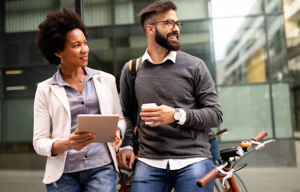 istock Business people talking outside with coffee, break relaxing time concept. 1286337040