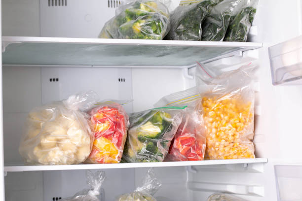 istock Plastic bags with deep frozen vegetables in refrigerator, closeup 1286337141