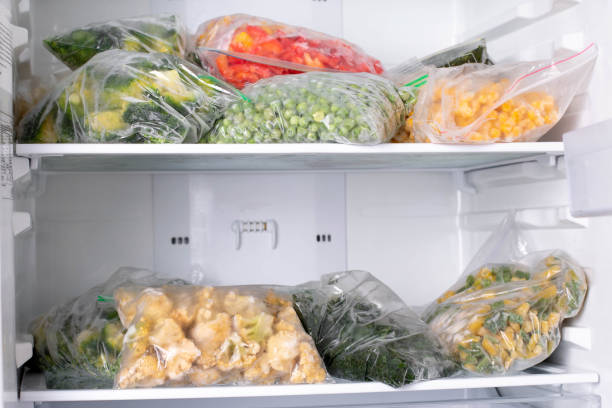 istock Plastic bags with deep frozen vegetables in refrigerator 1286337169