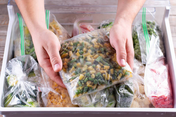 istock Frozen green beans. Frozen vegetables in a plastic bag in refrigerator 1286337196