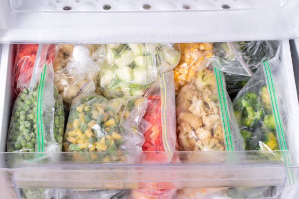 istock Plastic bags with deep frozen vegetables in refrigerator 1286337210
