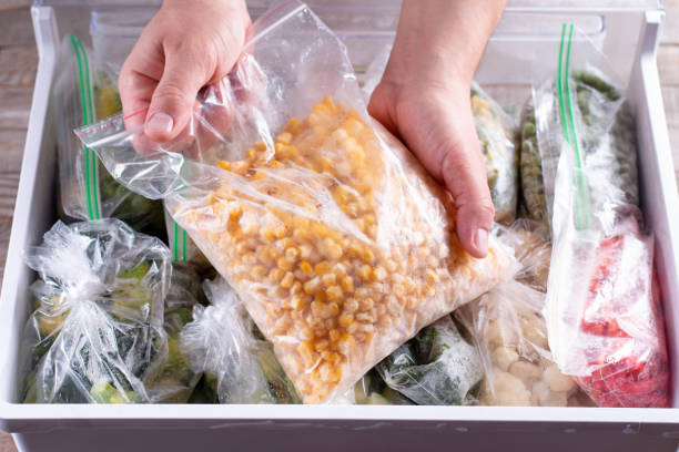 istock Frozen corn. Frozen vegetables in a plastic bag in refrigerator 1286337230