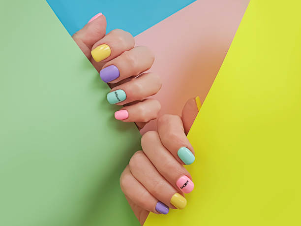 istock female hand beautiful colored manicure 1286337291