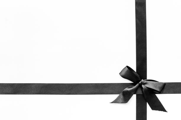 istock Black ribbon with bow isolated on white. Top view, copy space 1286338079