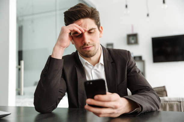 istock Serious young businessman using mobile phone. 1286338587