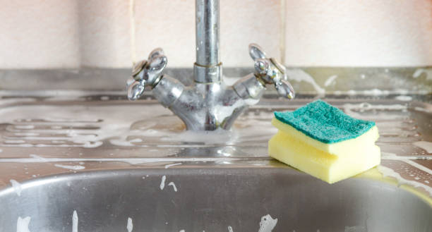 istock Sponge and foam solution on the kitchen sink. Cleanliness concept 1286339766