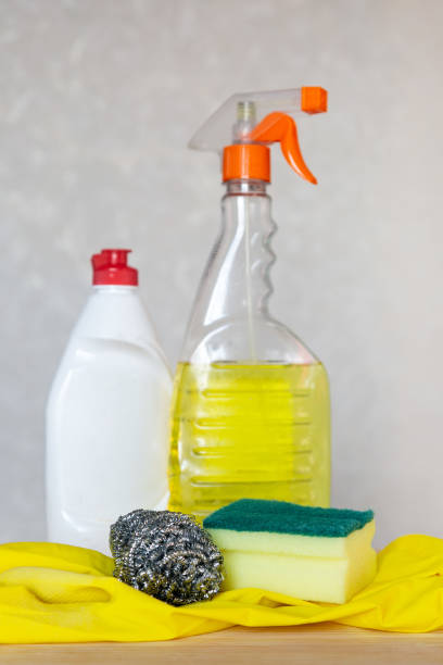istock Bottled cleaning agent and dishwashing set are on the table 1286339772