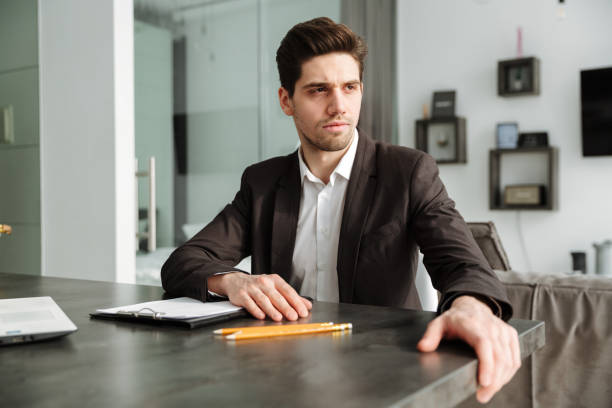 istock Serious young businessman working indoors 1286340702