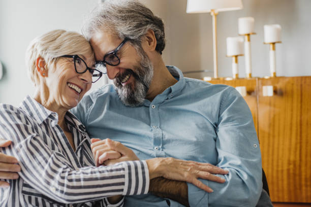 istock Senior couple embracing at home 1286340843