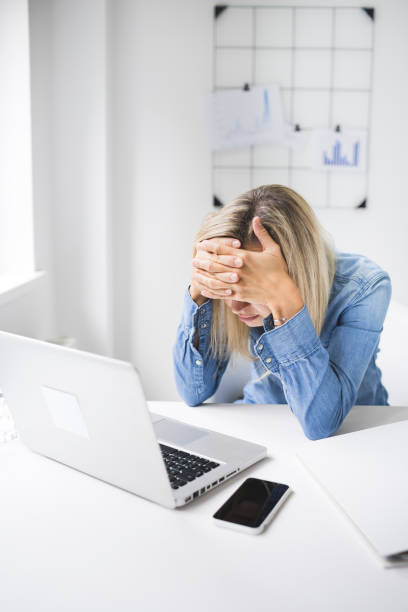 Revised tired woman in office Revised tired woman in office with burnout revised stock pictures, royalty-free photos & images