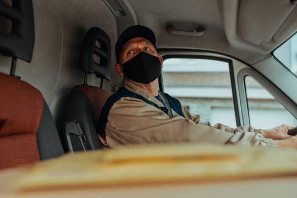 istock Postman delivering a package to a customer 1286343691