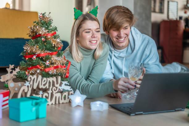istock Young couple celebrating Christmas and using a laptop at home 1286344461