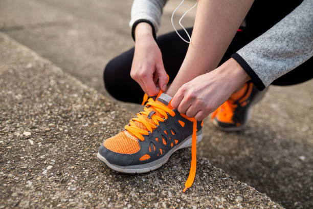 istock girl stop to tie a shoelaces 1286346005