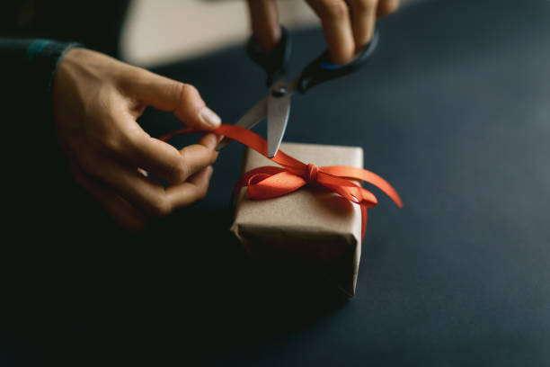 istock Packing gift box in organic paper on black background. 1286346025
