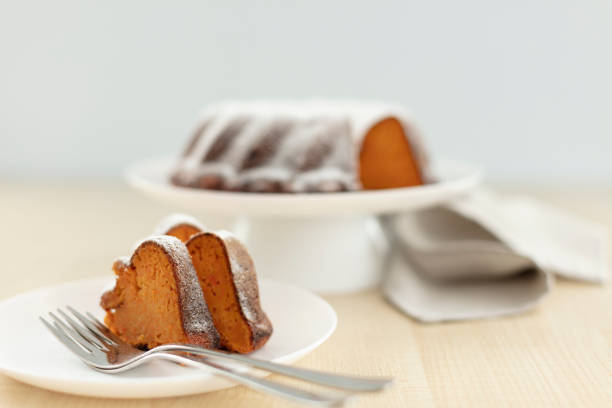 Carrot cake on a stand with powdered sugar. Selective focus