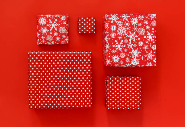 istock Gift boxes wrapped in red paper on red background 1286346466