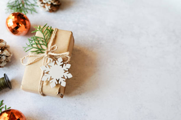 istock Christmas gift box with decorations on gray background, copy space 1286346522