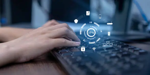 Photo of close up on programmer hand on keyboard computer desktop to access VPN mode during use internet data telecommunication with interface icon for future network communication technology concept