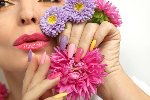 istock Fashionable multi-colored makeup and manicure on long nails 1286348555
