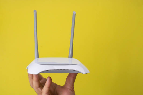 istock Male hand holds a router on a yellow background. 1286348689