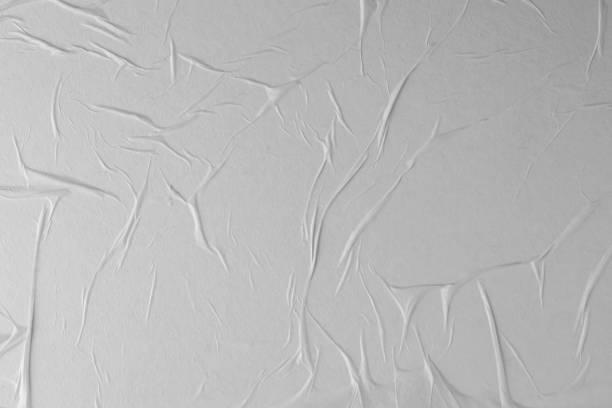 istock Crumpled white paper. Blank street poster texture. 1286348703