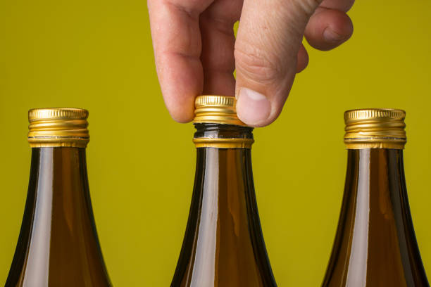 istock A man's hand removes the cap from a glass beer bottle. 1286348809