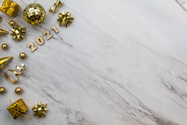istock Festive 2021 background gold decor on marble border flat lay copy space 1286348959