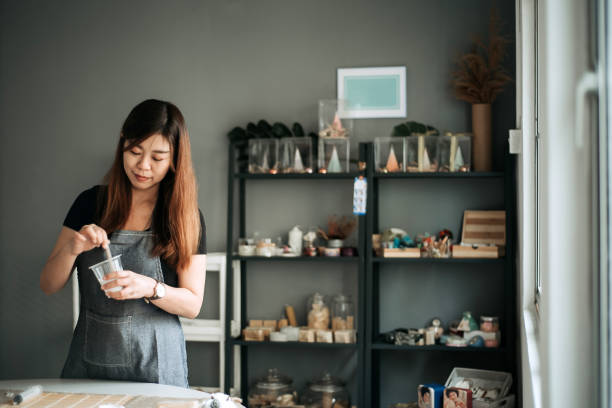 Asian chinese female holding a cup and stirring on it