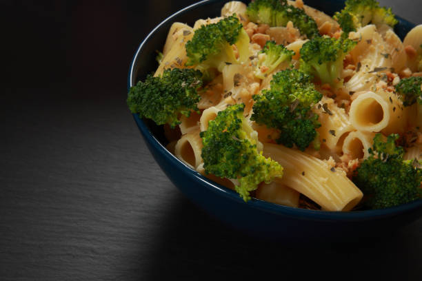 Broccoli and Pasta A healthy meal including Broccoli on a bed of Pasta with crushed Peanuts sprinkled on top convenience food photos stock pictures, royalty-free photos & images